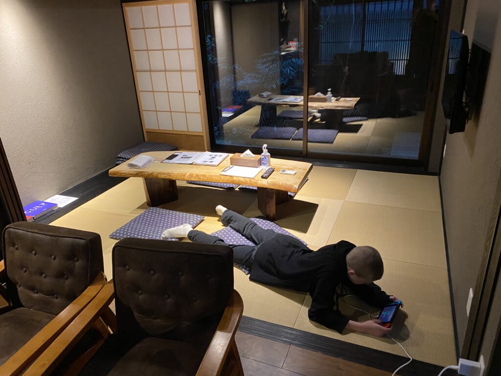 a boy lying on the floor with a phone in his hand