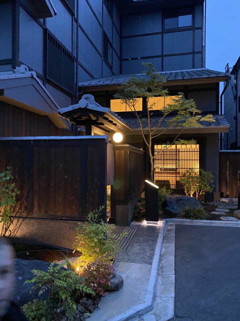 a building with a fence and a tree