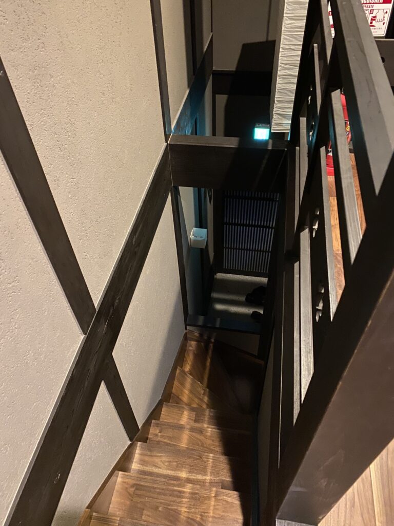 a staircase with a wood railing