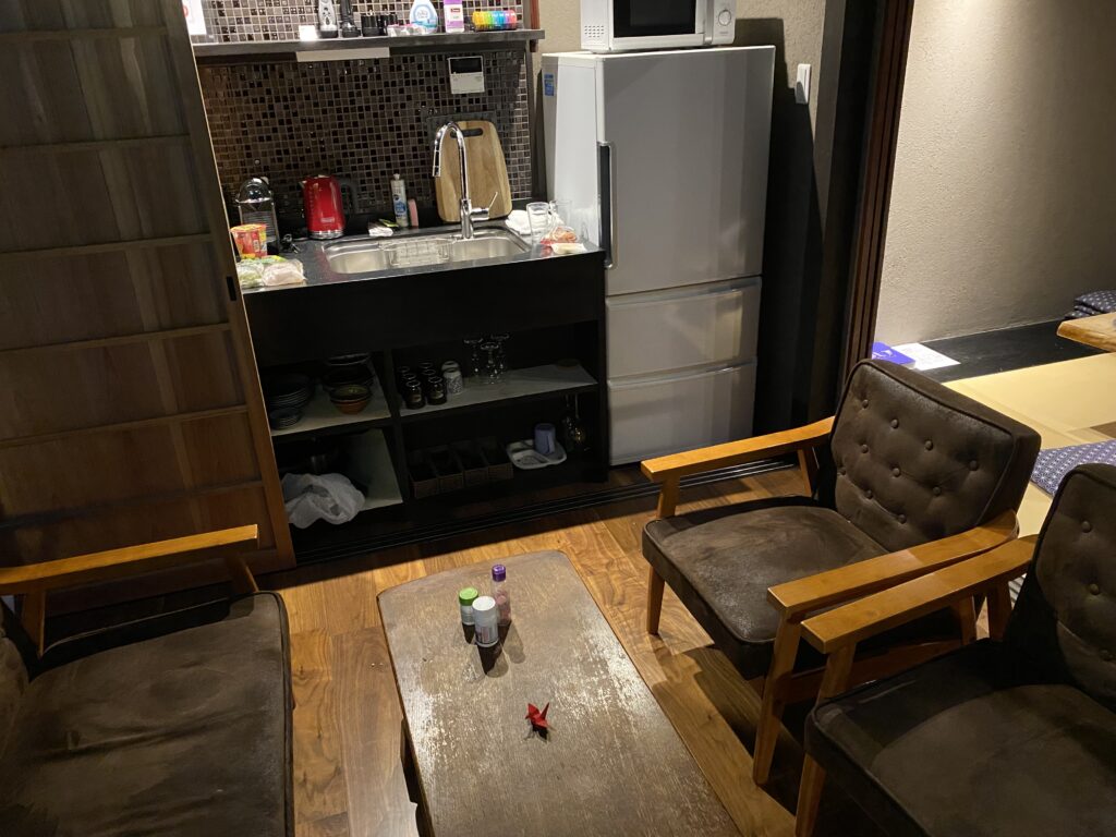 a small kitchen with a sink and chairs