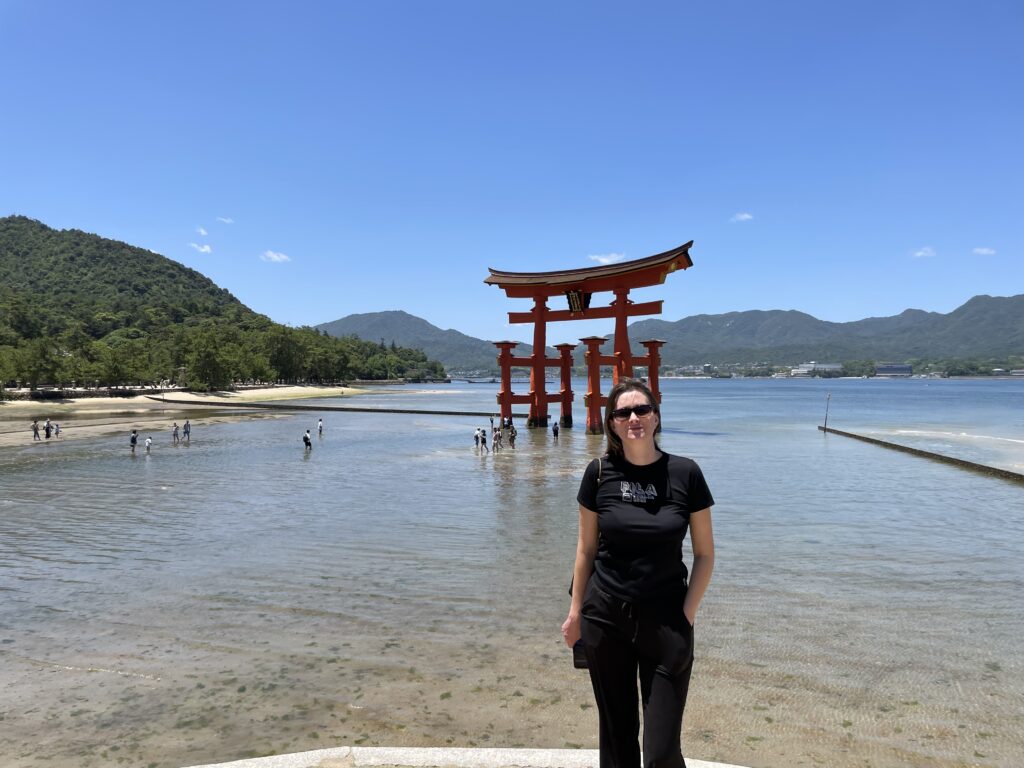 a woman standing in front of a red structure