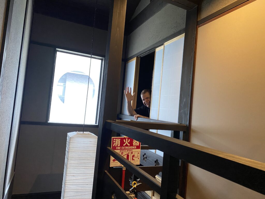 a man waving from a window