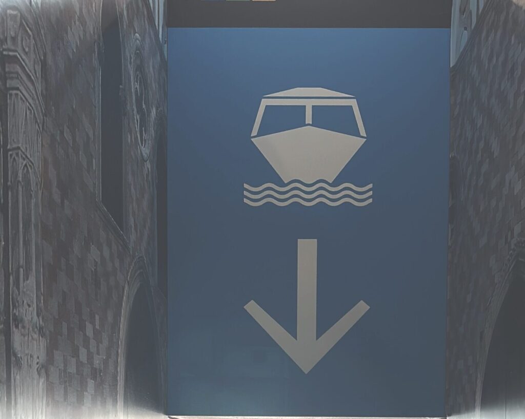a blue sign with a boat and arrow