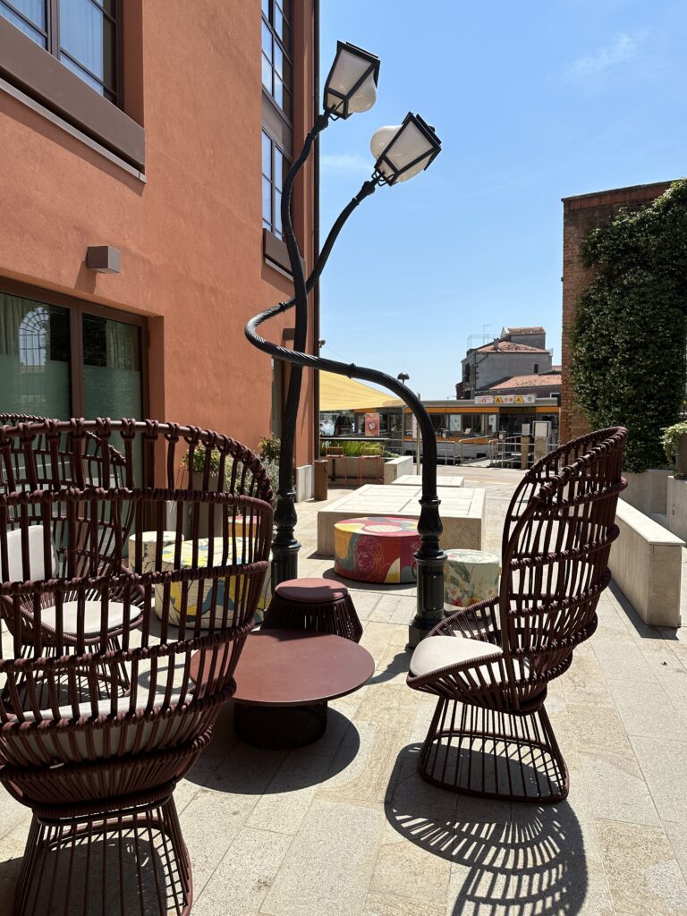 a lamp post and chairs outside of a building