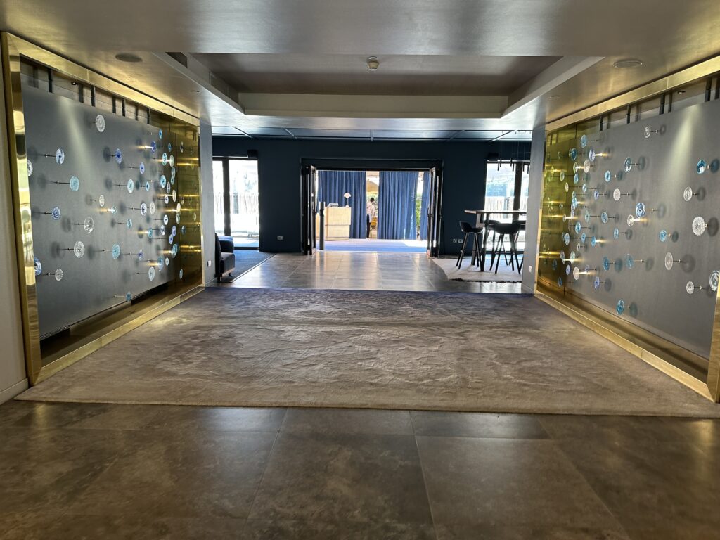 a hallway with a wall with blue circles on the wall