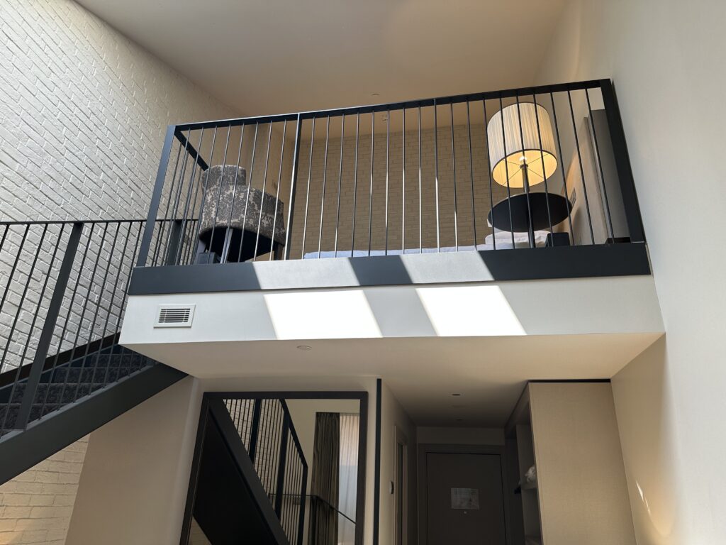 a black railing on a white wall