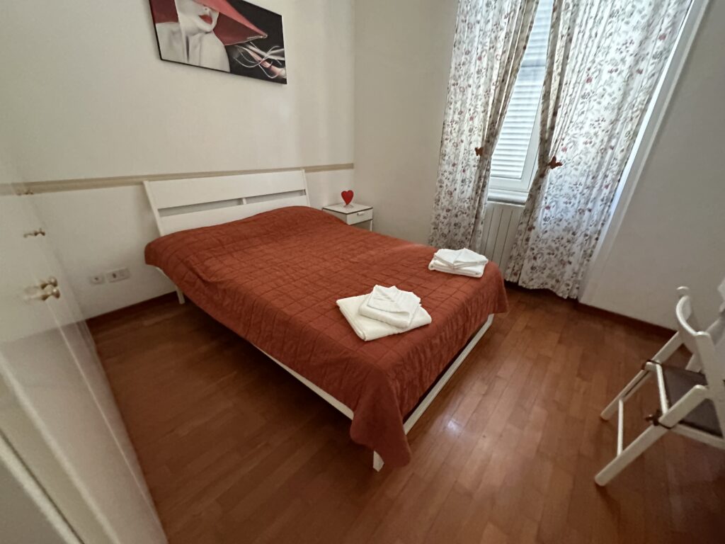 a bed with a red blanket on it