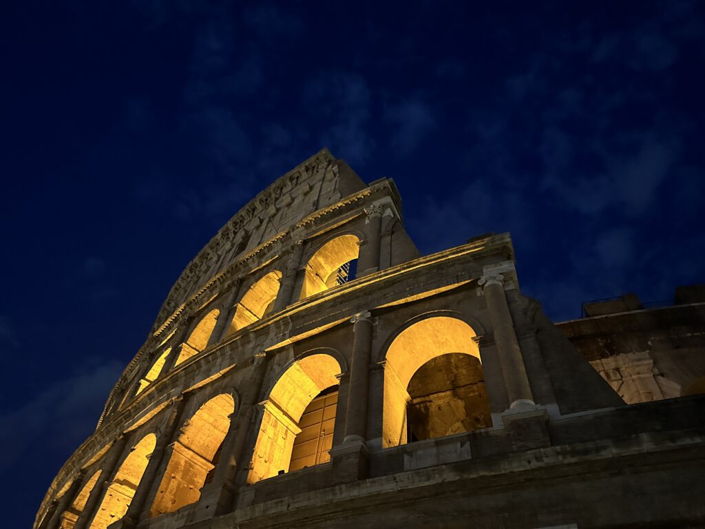 a stone building with arches and lights