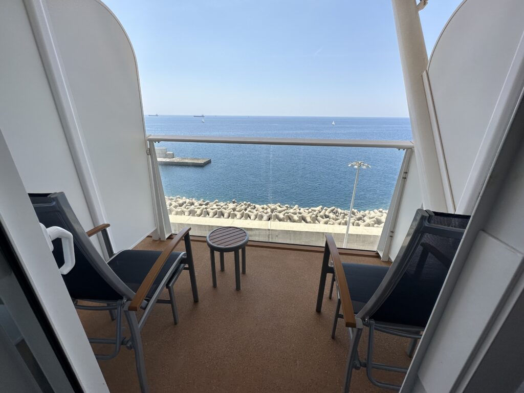 chairs on a balcony overlooking the ocean