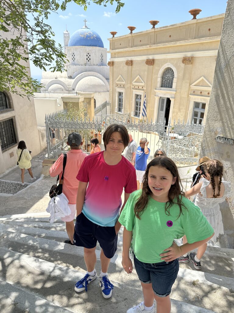 a group of people standing on stairs in front of a blue domed building