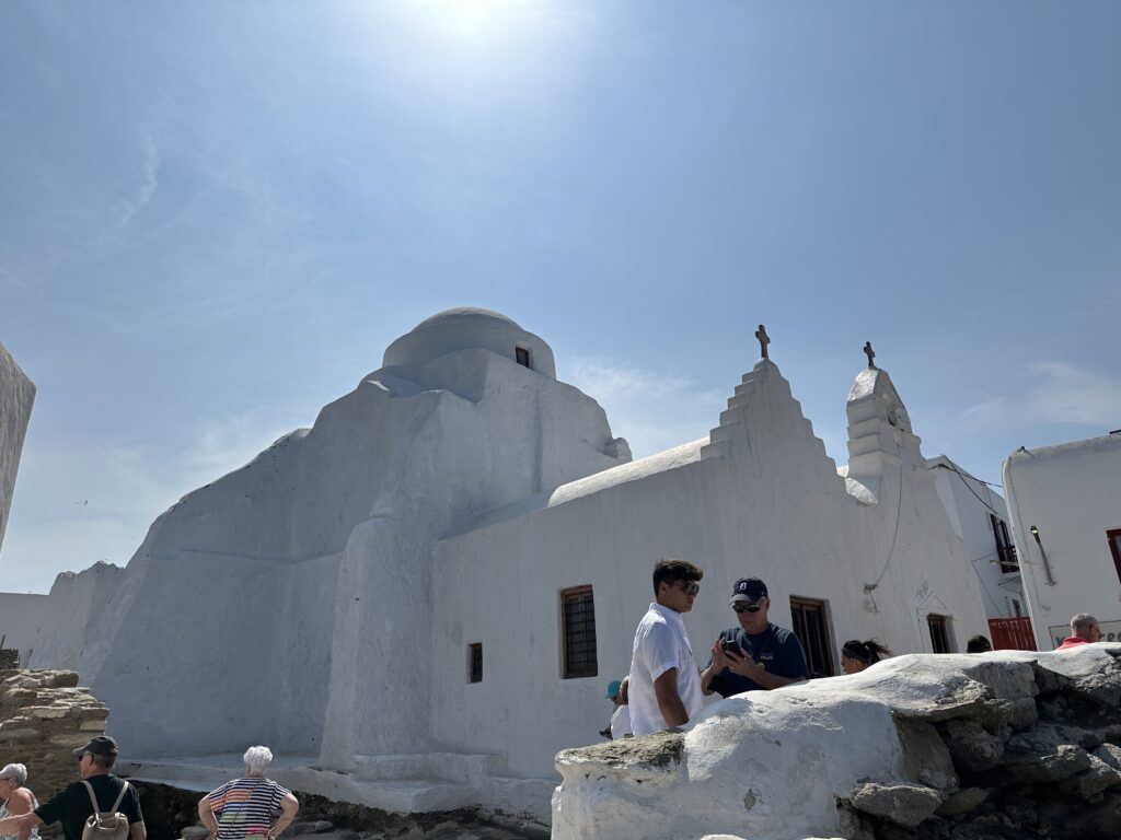 a group of people outside a white building