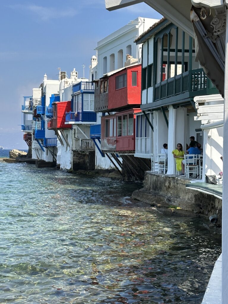a row of colorful buildings along a body of water