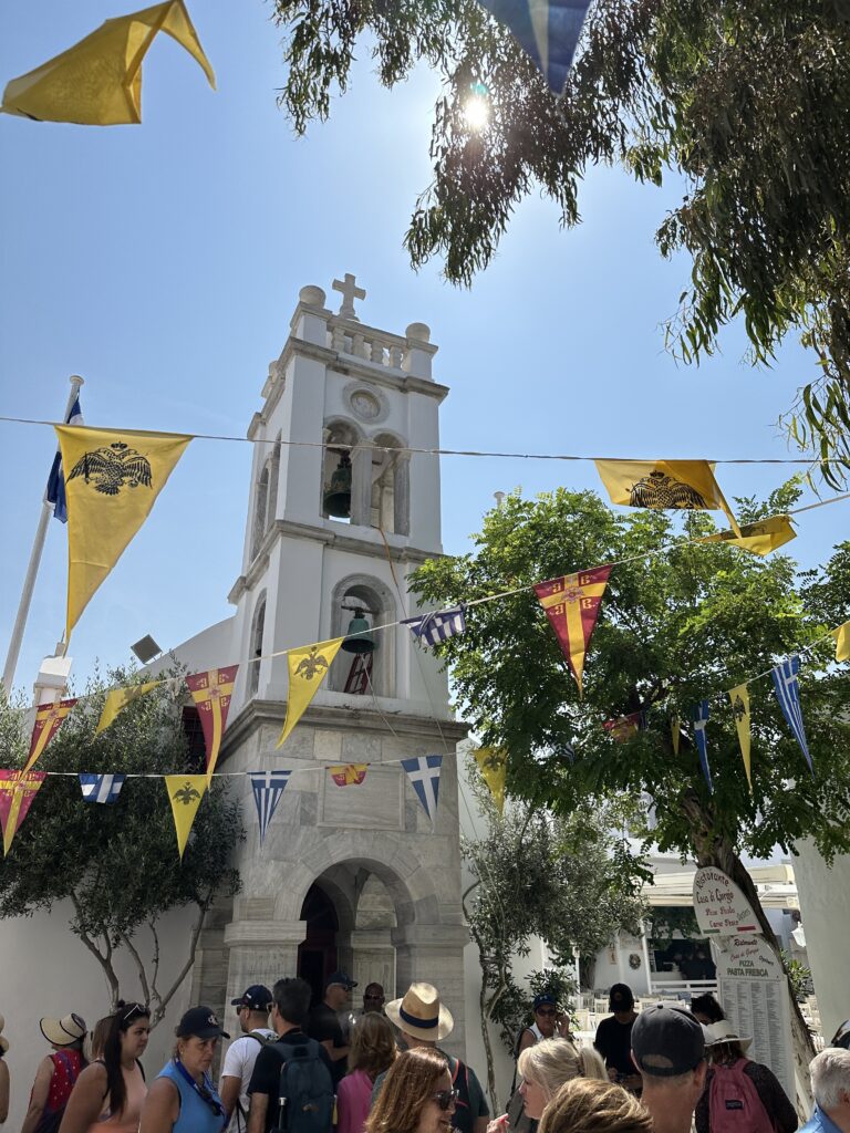 a church with a bell tower and flags