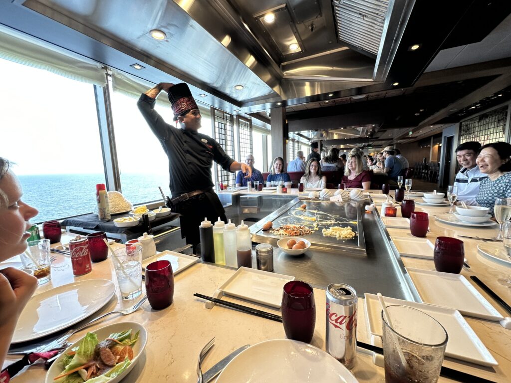 a man in a hat standing in a restaurant with people around it