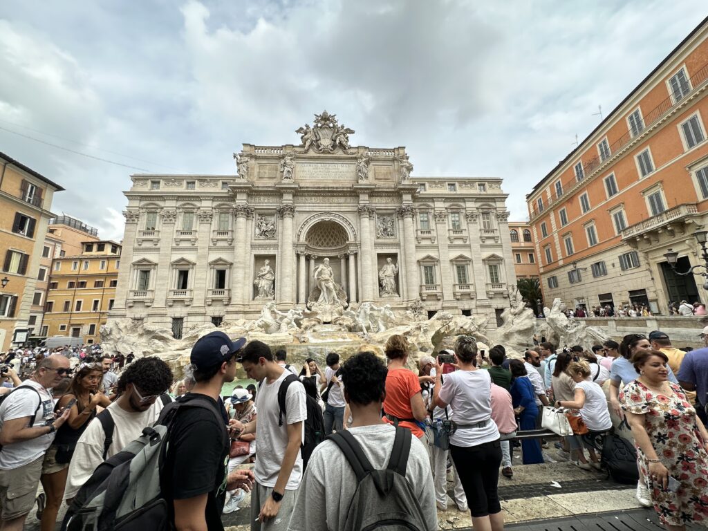 a group of people standing in front of a large building