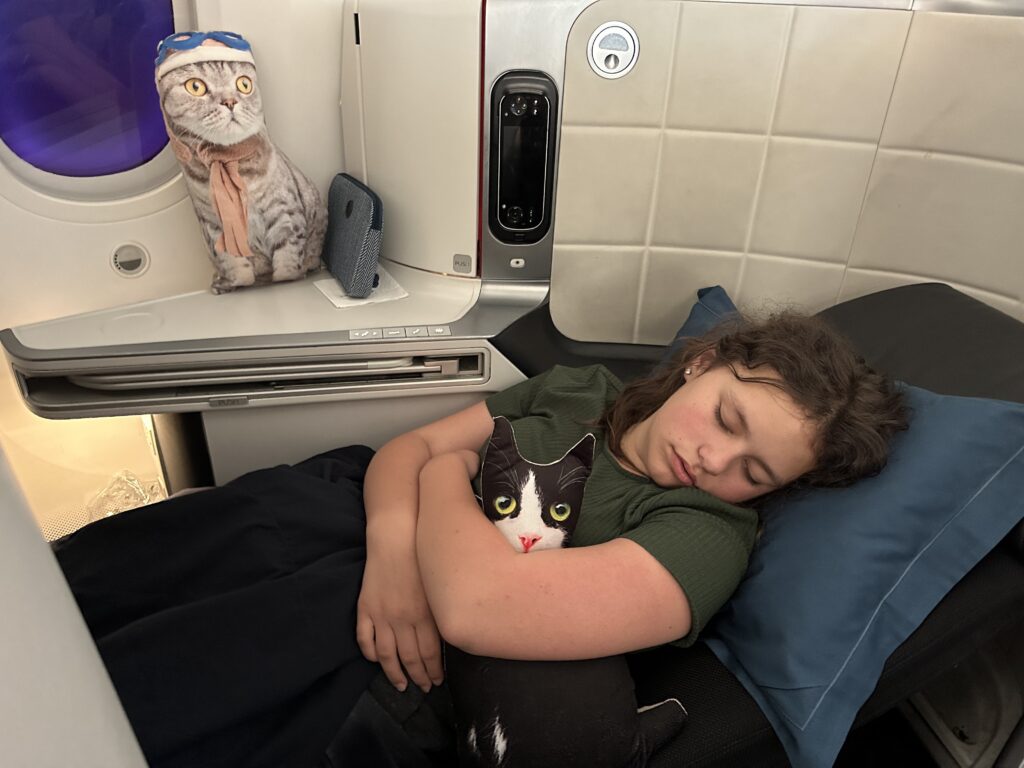 a woman sleeping with a cat toy