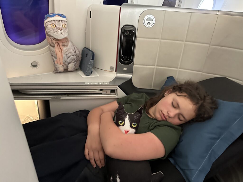 a woman sleeping with a cat