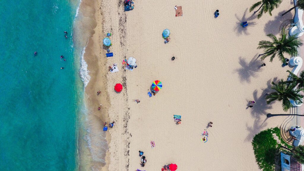 aerial view of a beach with umbrellas and people on it