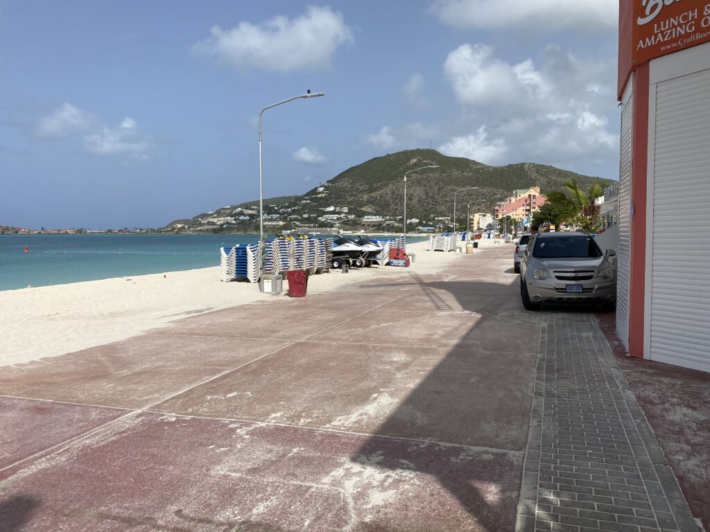 a beach with cars parked on the side
