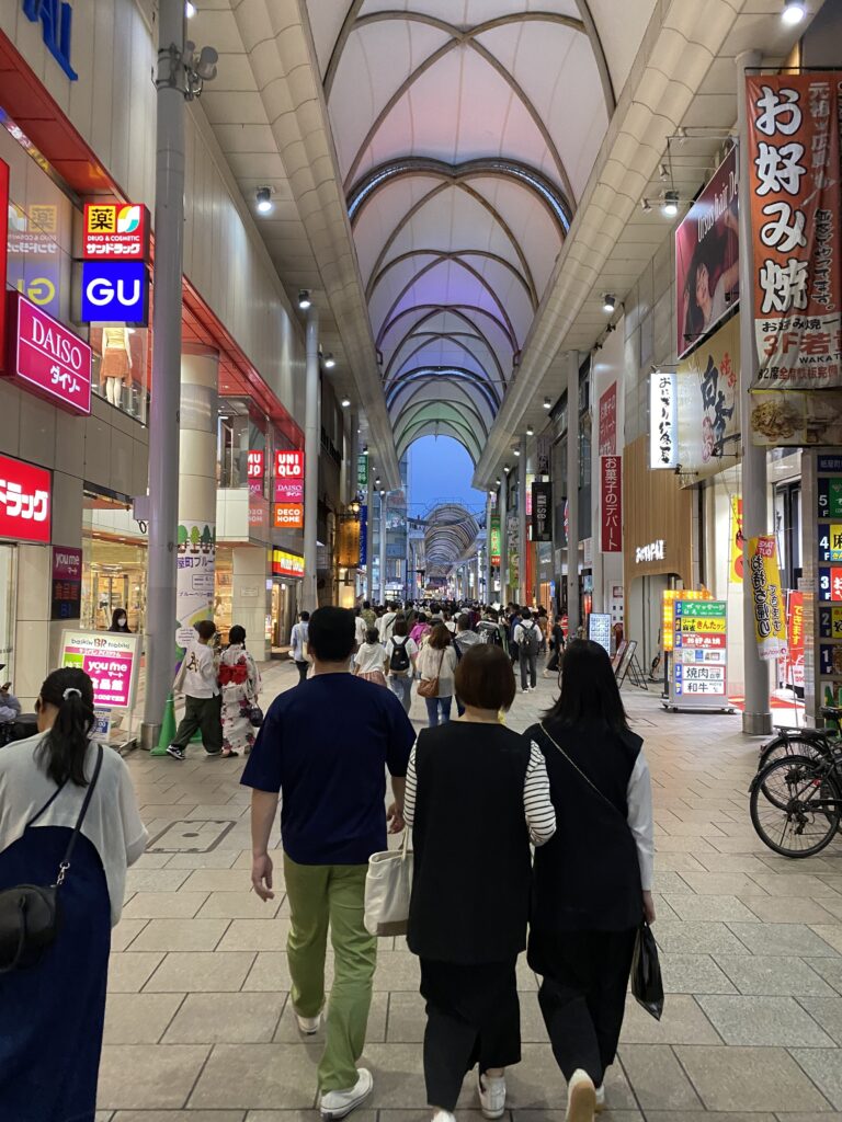 a group of people walking in a shopping street