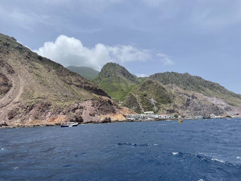 a body of water with mountains and buildings