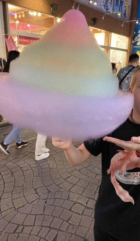 a boy holding a cotton candy