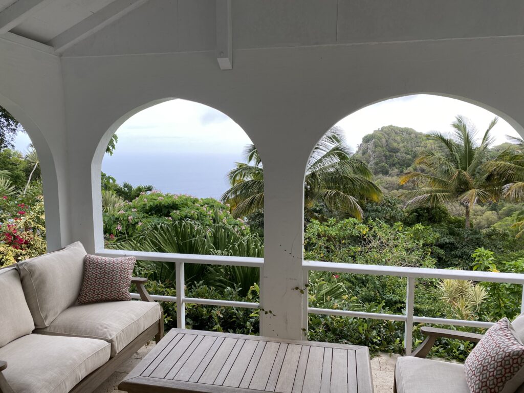 a patio with a view of the ocean and trees