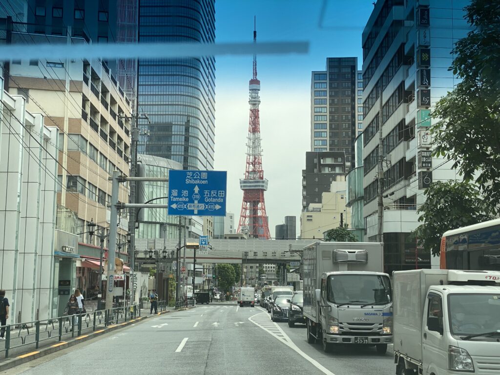 a street with cars and buildings in the background