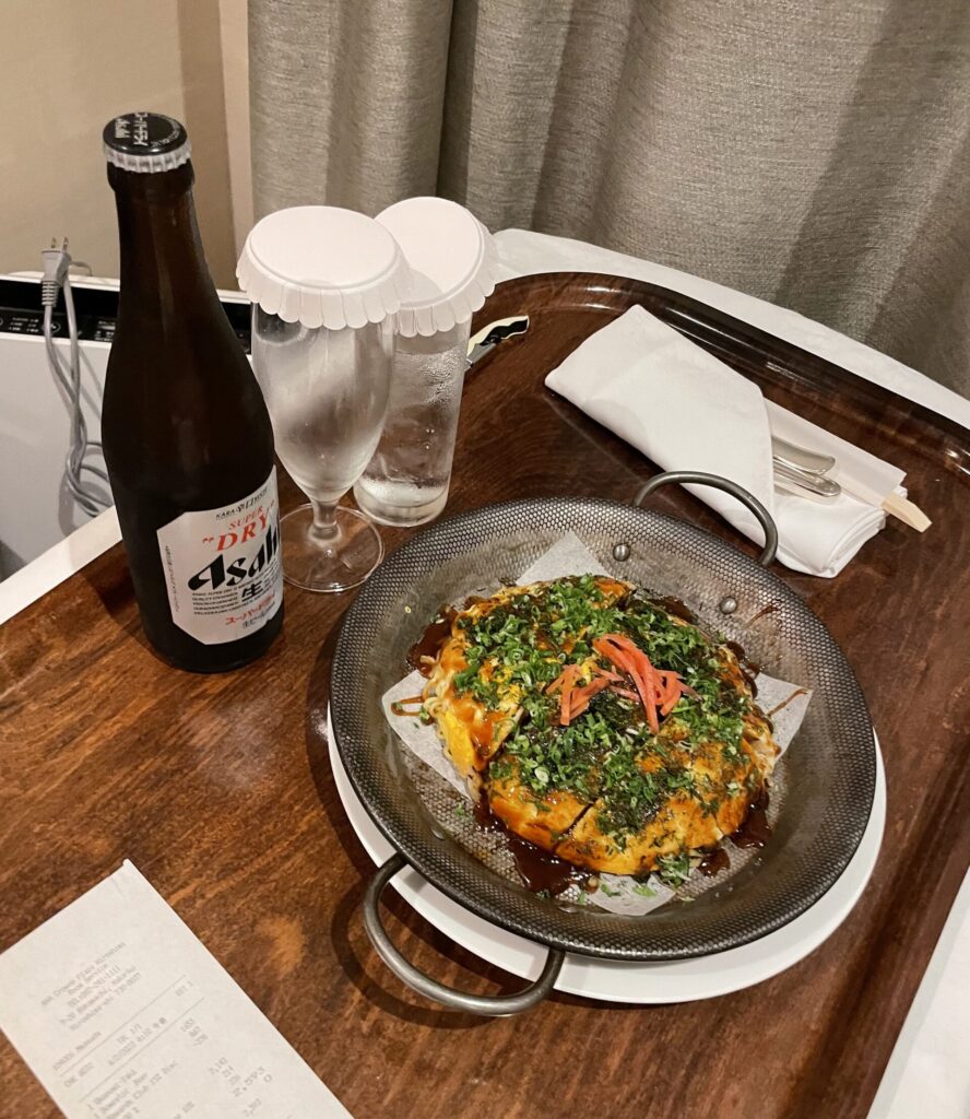 a plate of food and a bottle on a tray