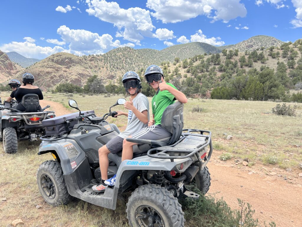 two people on a four wheeler