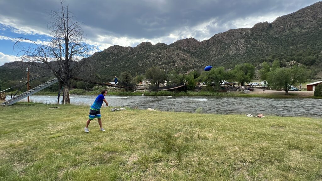 a boy playing with a blue frisbee