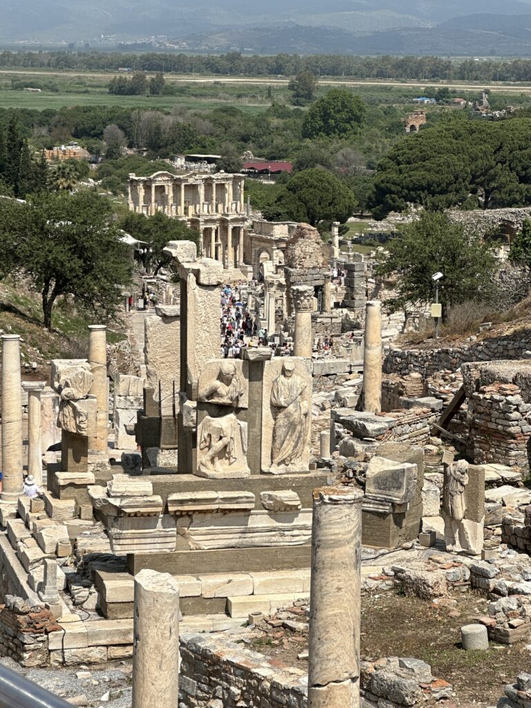 a group of people walking around a ruins