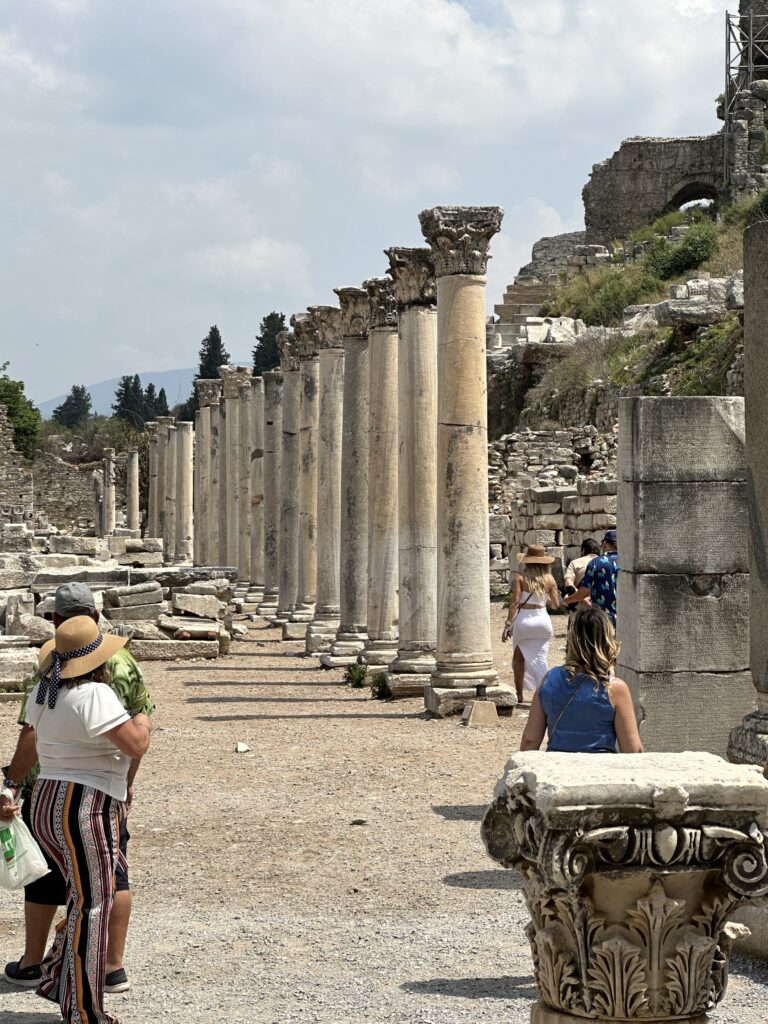 a group of people walking around a stone structure