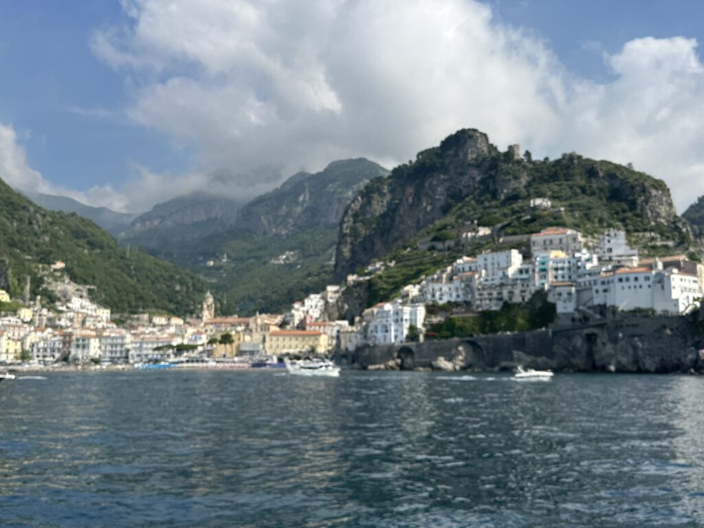 a body of water with buildings and mountains