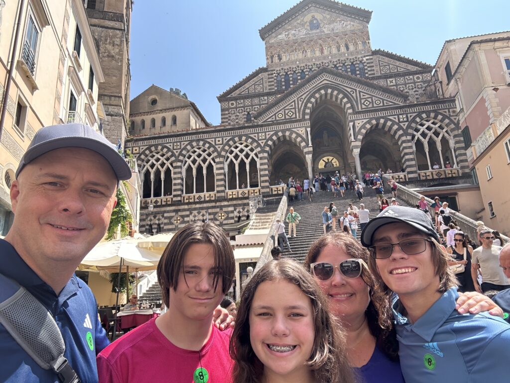 a group of people posing for a photo in front of a building
