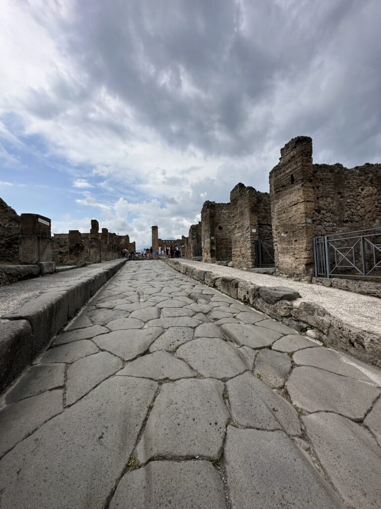 a stone road with people walking on it
