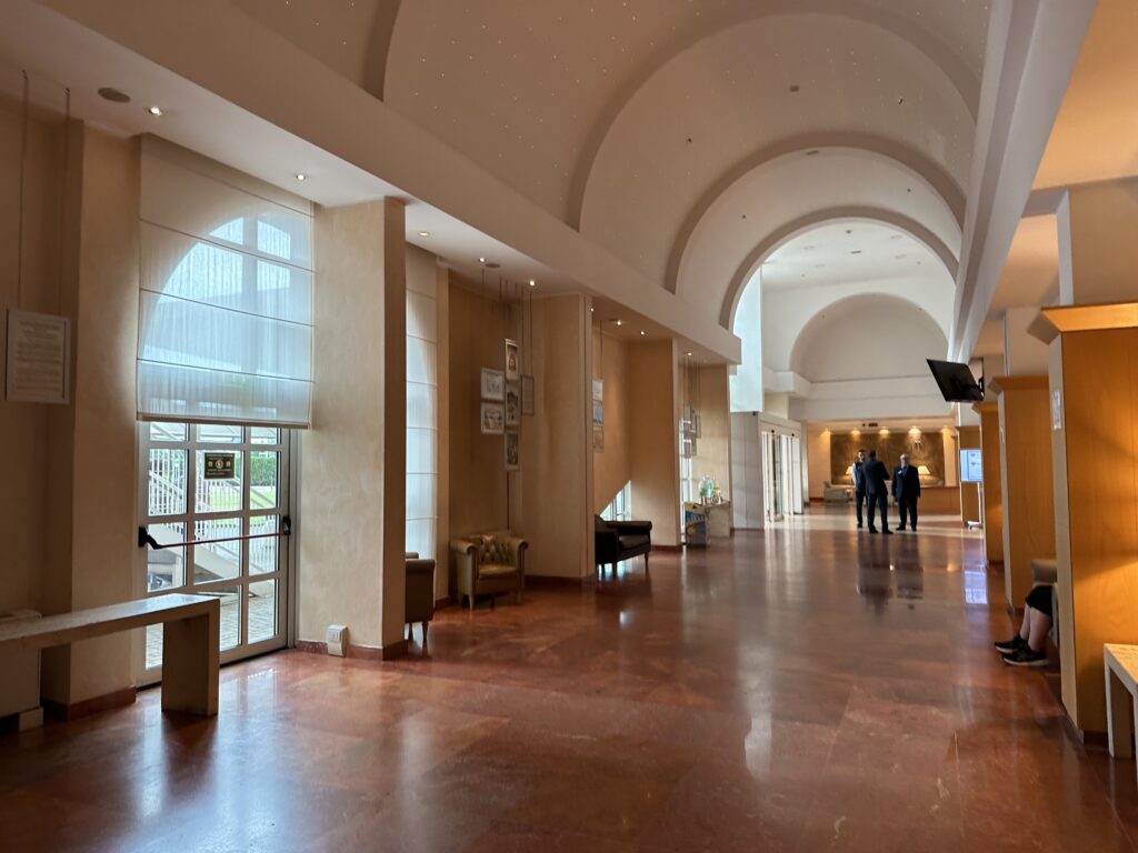 a large hallway with a couple of people walking