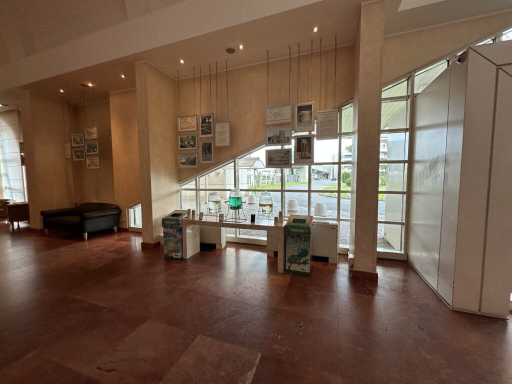 a room with a staircase and pictures from the ceiling