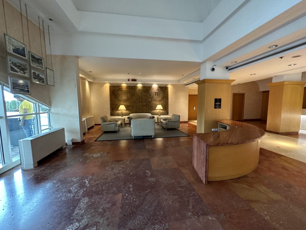 a lobby with a reception desk and chairs