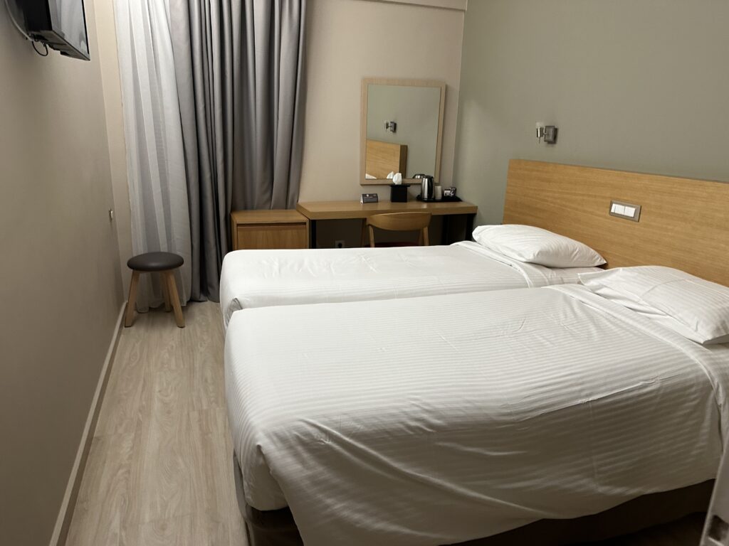 a room with two beds and a mirror