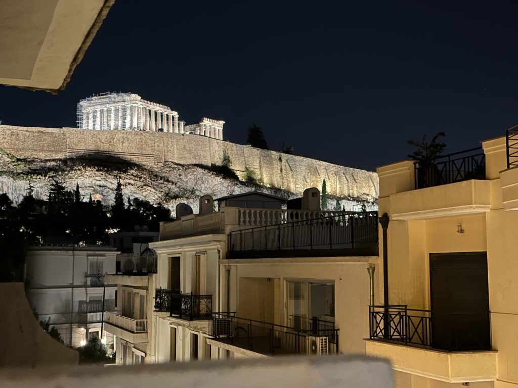 a building on a hill with lights at night