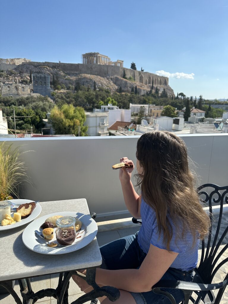 a woman eating food on a balcony
