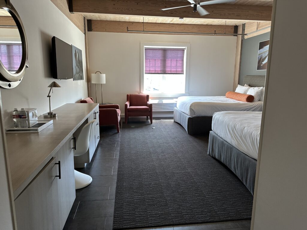 a room with two beds and a tv