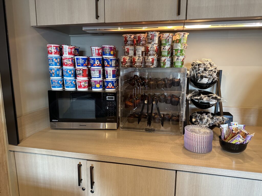 a counter with a microwave and food items on it