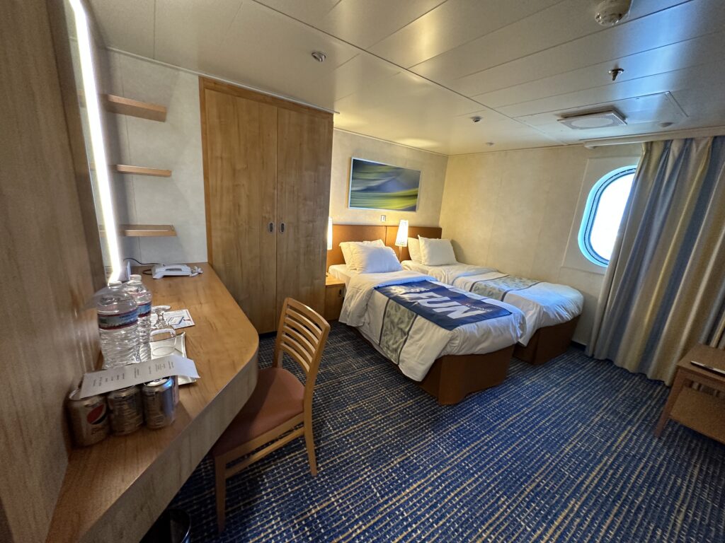 a room with two beds and a desk