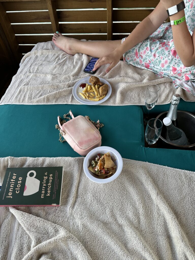 a woman sitting on a bed with food on it