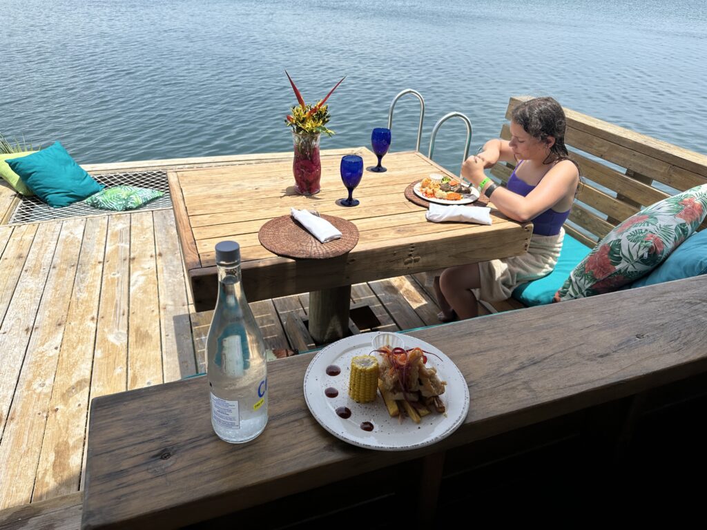 a woman sitting at a table with food on it