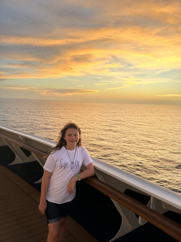 a girl standing on a deck of a ship