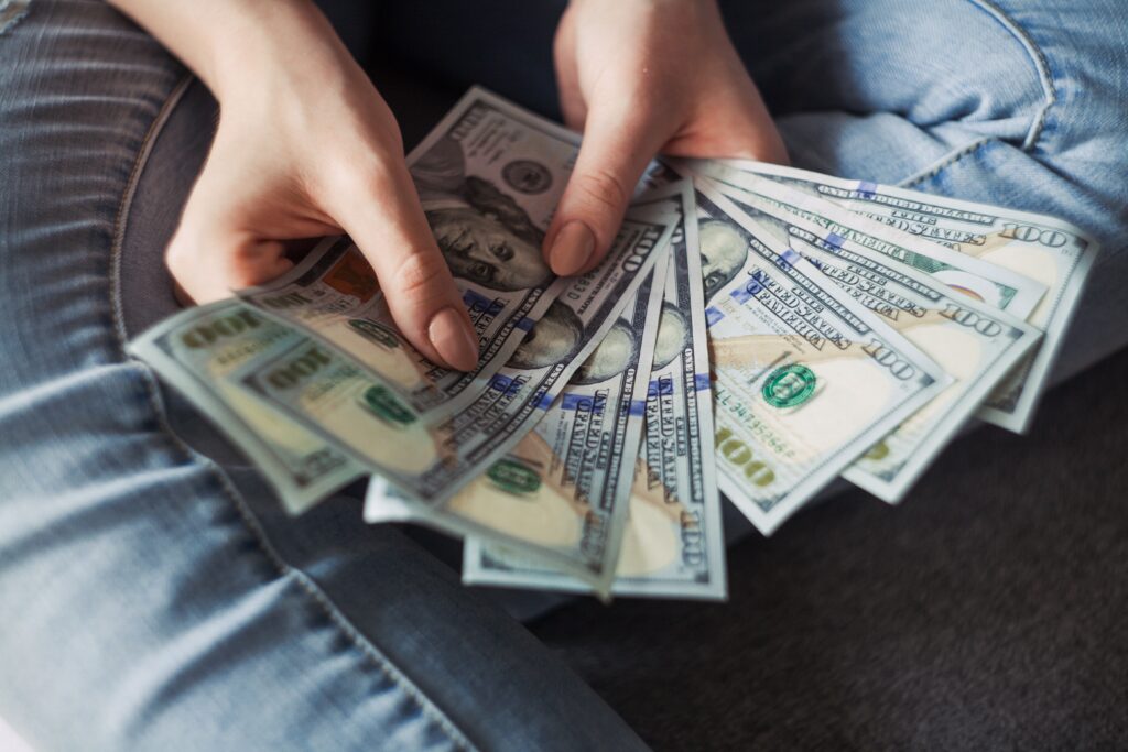 a person holding money in their hands