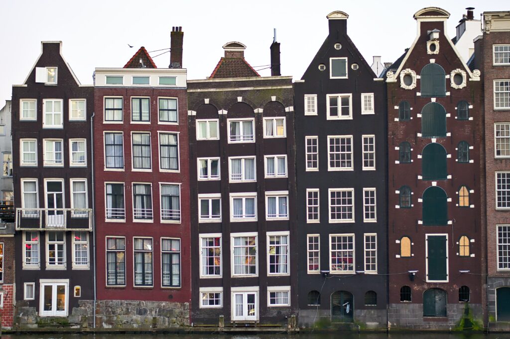 a row of buildings next to a body of water